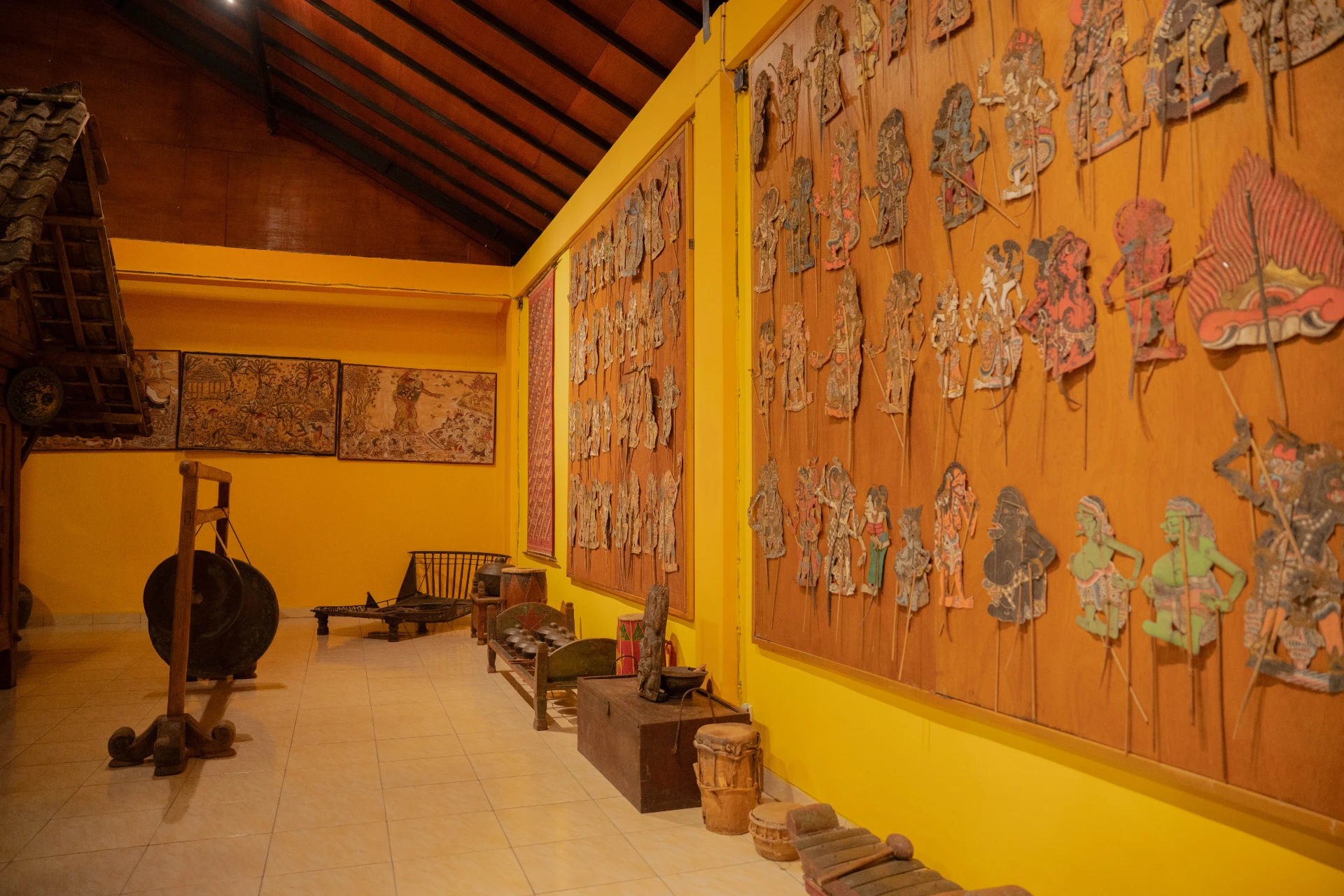 Cultural heritage gallery of the Tuban Room featuring a blend of Indonesian folk art, music, and textiles.