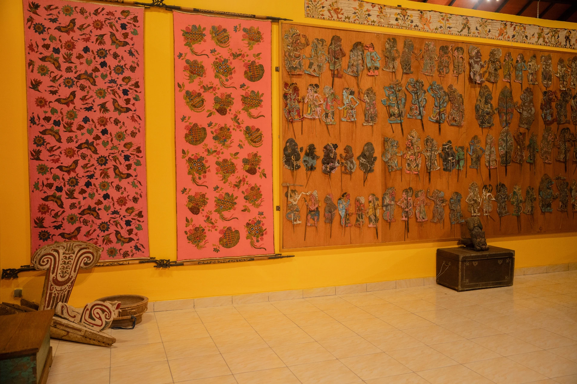 Unique Balinese hand-woven textiles and traditional fabrics hung as cultural exhibits in the Tuban Room.