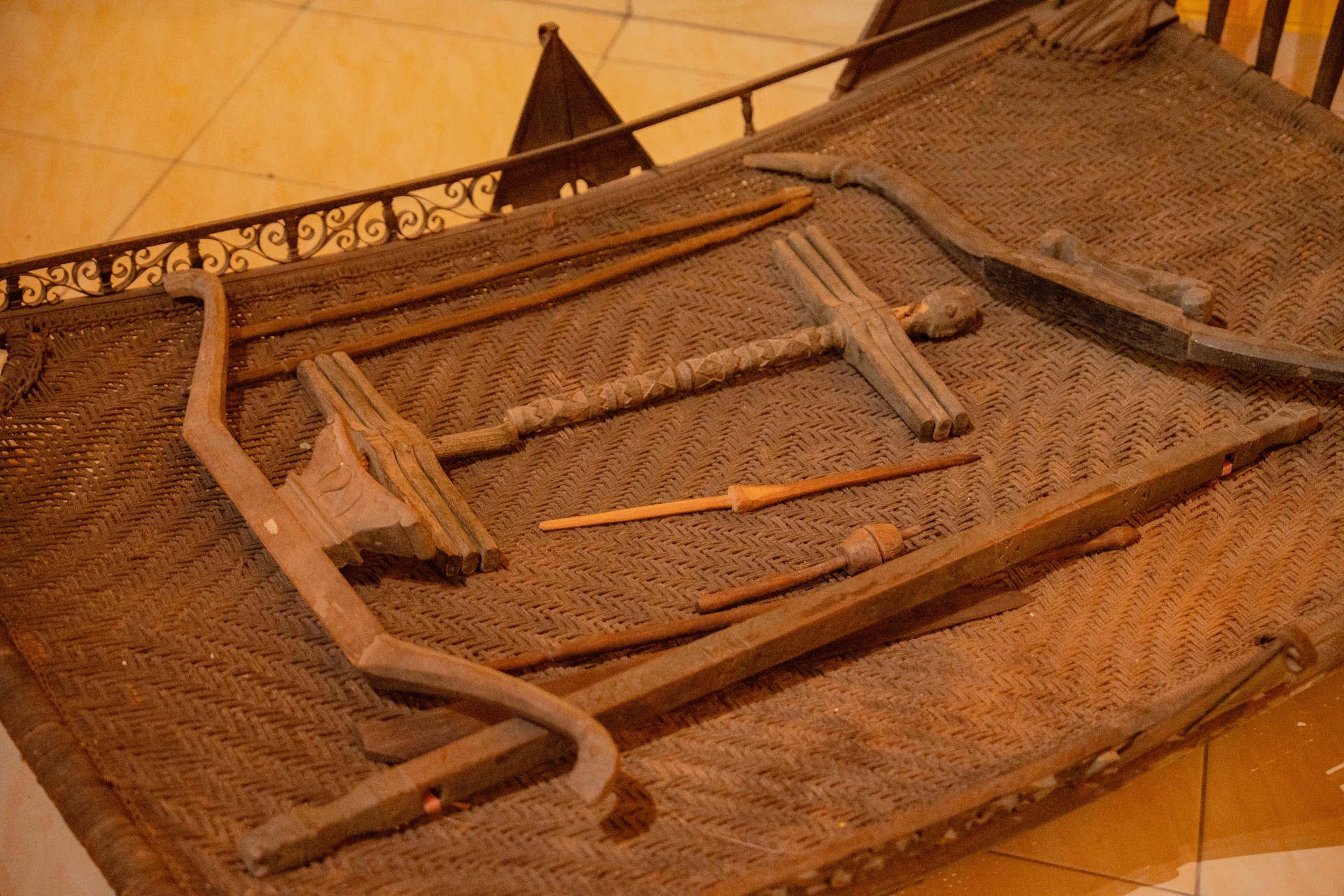 Authentic Indonesian keris daggers and historical weaponry displayed on the red walls of the Tuban Room.