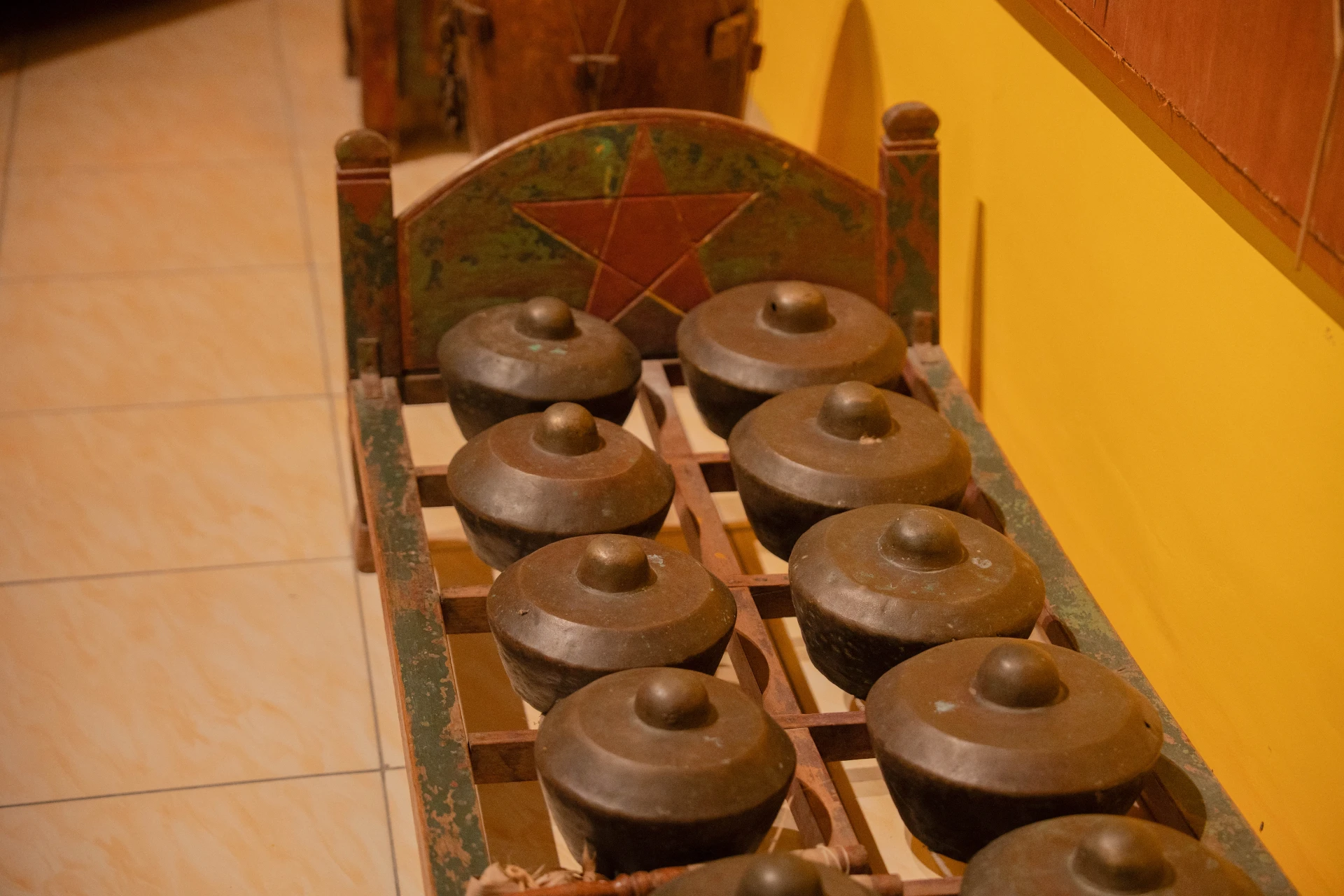 Traditional Balinese musical instruments including a rebab and bronze gamelan set inside the wooden Tuban Room.