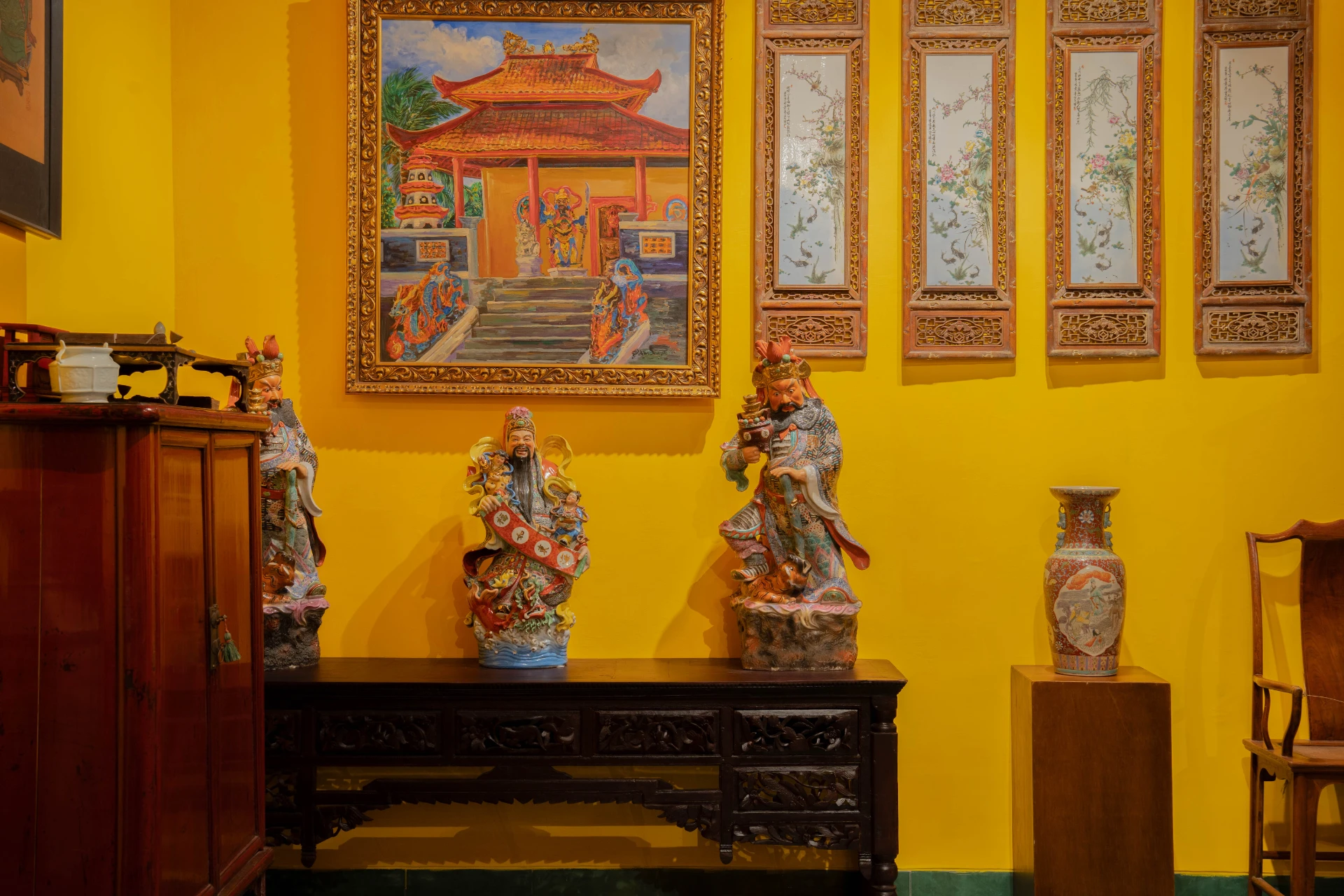 Slender bronze Bodhisattva figures displayed against traditional purple textiles, Museum Peter Bloch Collection.